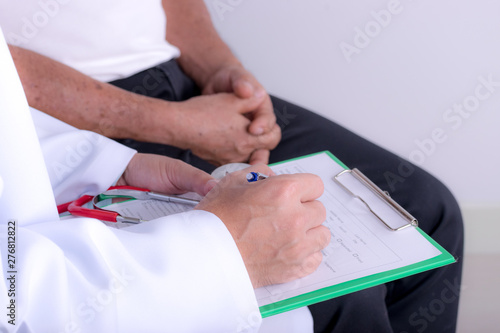 Doctor hands with cardiogram chart with pen. Cardiologist explaining his patient EKG results.