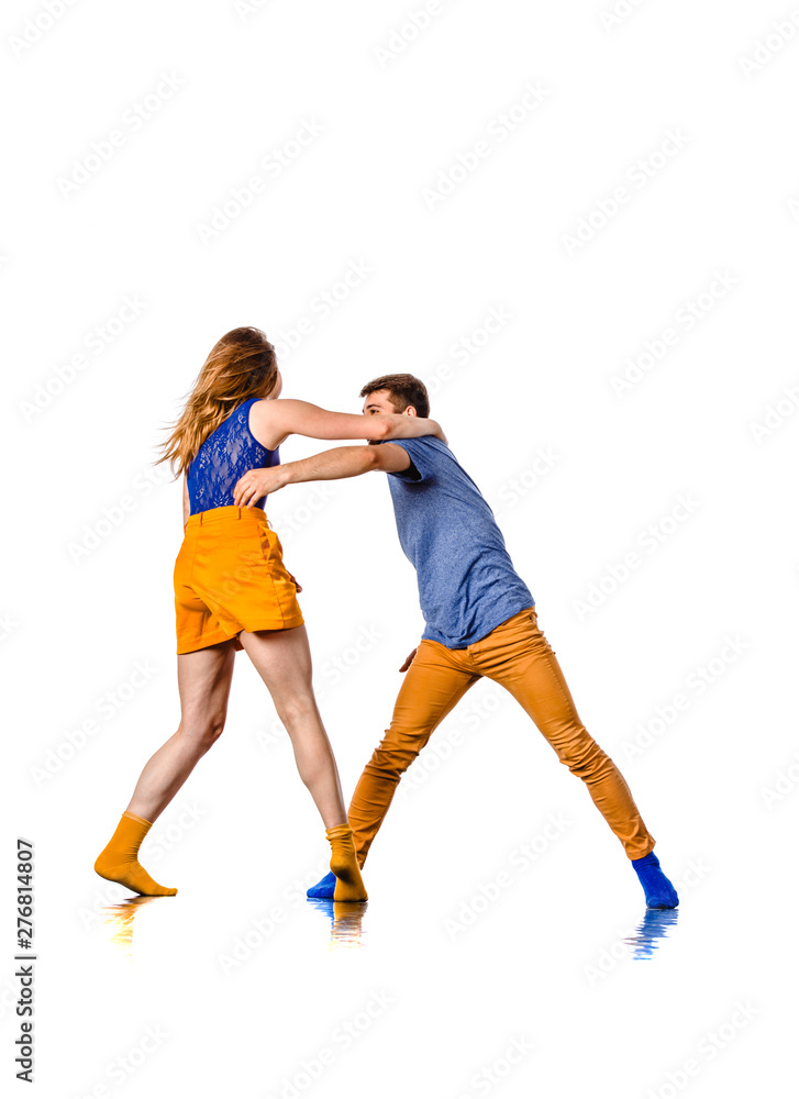 Dancing young couple on a white background