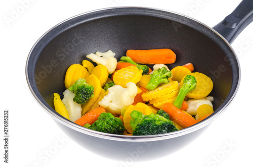 Frying pan with mix of frozen vegetables, isolated on white background.