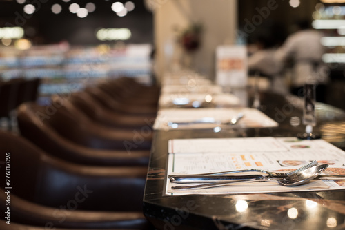 Empty room nobody Classic style of Restaurant with wooden table leather high chair with fork knife spot low light, interior design with calm and business discussion talk or private dinner couple