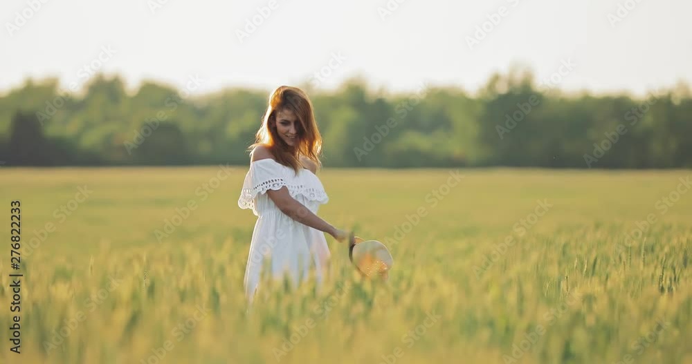 Walk in nature in the summer. Young beautiful woman whirls in the field and rejoices. Walk in nature in the summer. Young beautiful woman whirls in the field and rejoices.