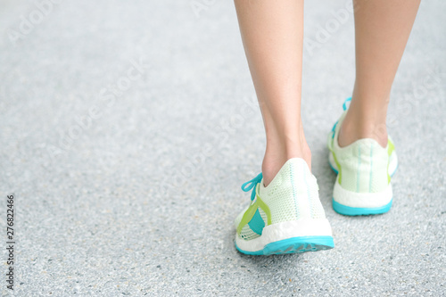 Leg of woman which runner athletic by running shoes is on the ground to walk exercise in the morning. Health and Relaxation Concepts. Healthy lifestyle