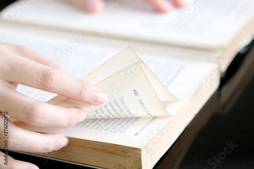 Hand of beautiful woman open a book reading in the library. On weekends.Educational Ideas