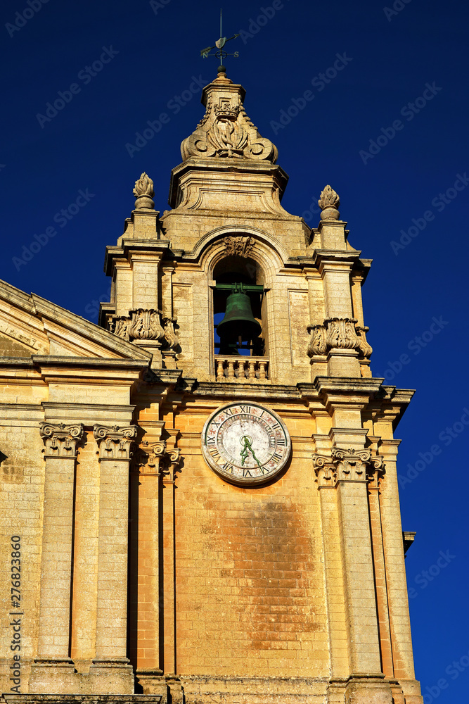Detail shot from ancient old church exterior in historic district of malta city over blue sunny sky in Mediterranean island Malta