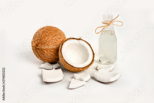 Coconut with half and coconut oil on white background.