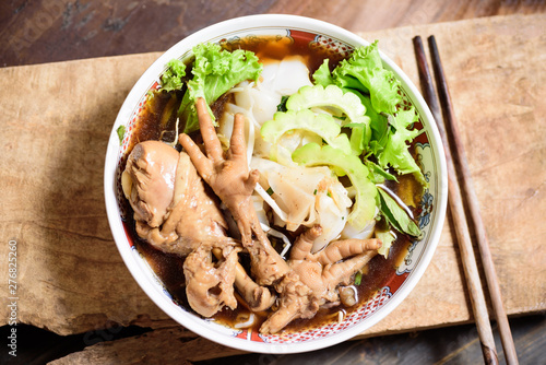 Rice noodles soup with stewed chicken wing and feet in a bowl