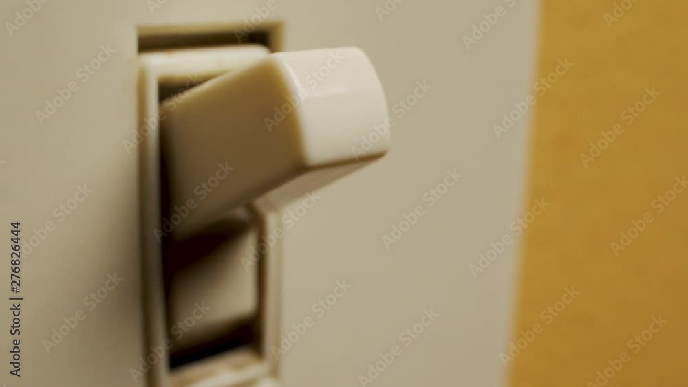 Macro shot of a finger turning on a light switch