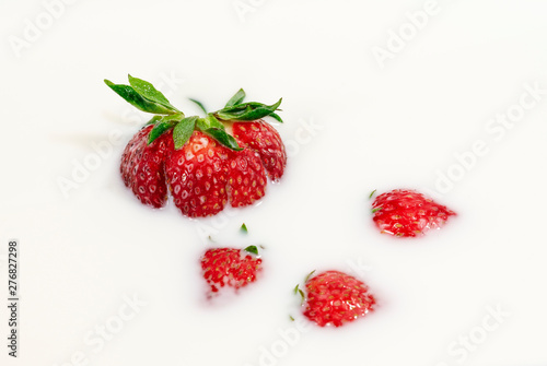 Red natural ripe strawberries in milk cream