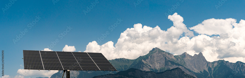 large free-standing solar panel with panorama mountain landscape in the Swiss Alps