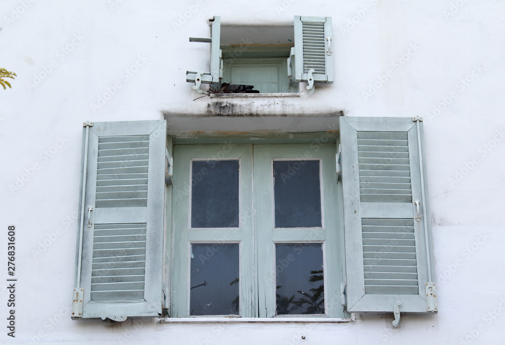 Open louver window on white concrete wall. Open louver window on white concrete wall.