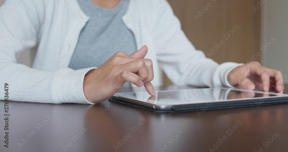 Woman work on tablet computer at home Woman work on tablet computer at home