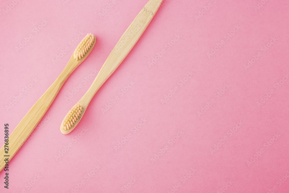 Bamboo toothbrushes on pink background Bamboo toothbrushes on pink background
