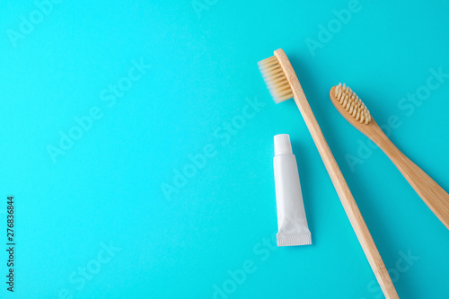 Bamboo toothbrush with toothpaste on blue background