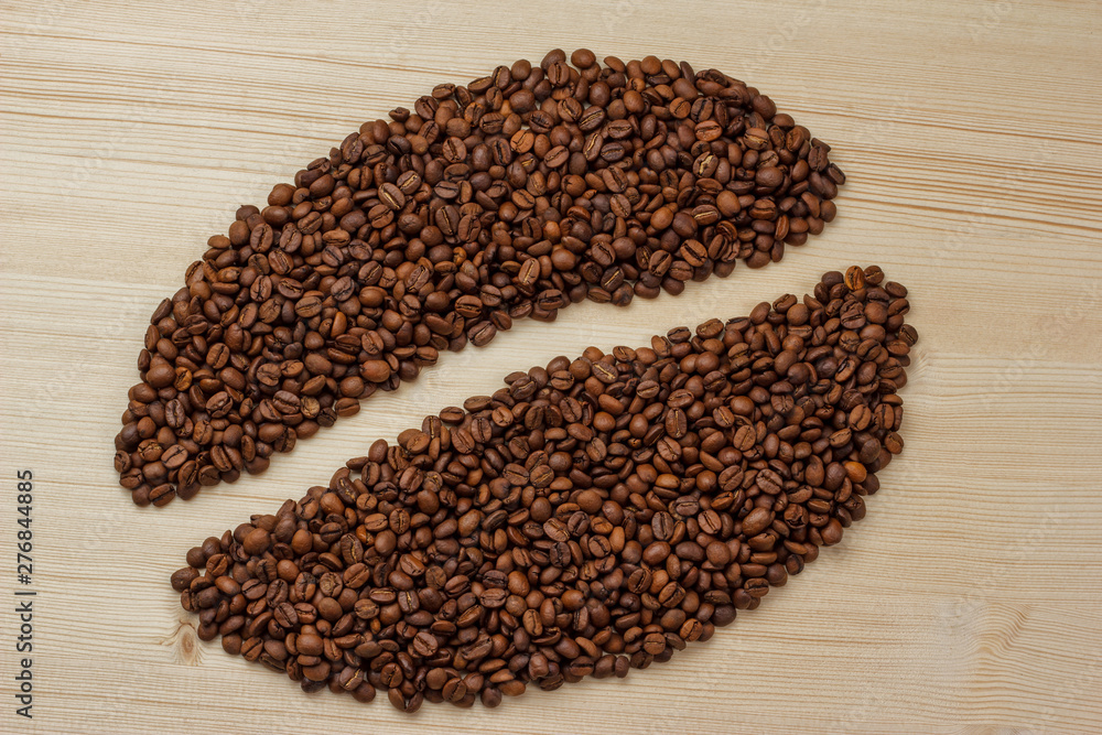 coffee bean logo made from coffee beans on a wooden background coffee bean logo made from coffee beans on a wooden background