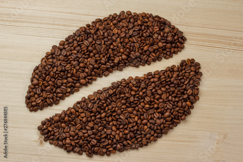 coffee bean logo made from coffee beans on a wooden background