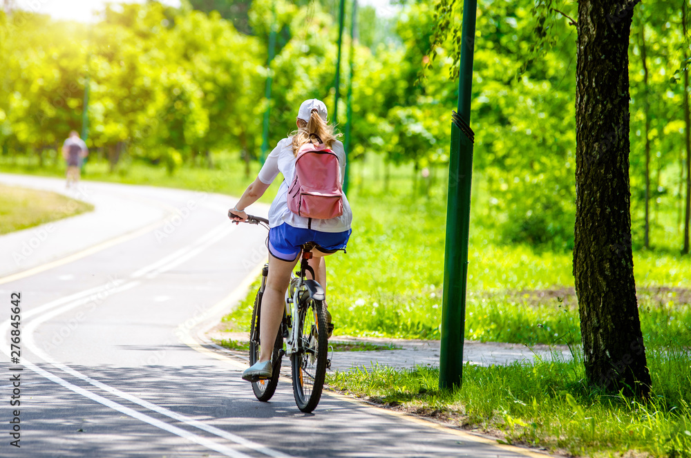 Naklejka premium Cyclist ride on the bike path in the city Park 