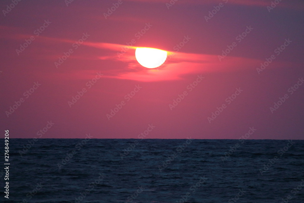 evocative immagine of sunset over the sea with red sun