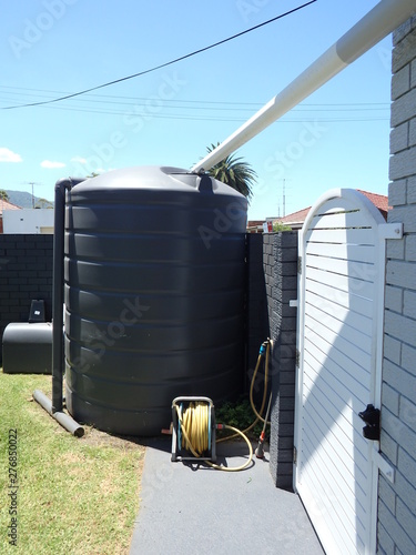 Canvastavla Rain collection water tank installed in a suburban house