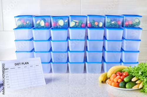 A meal plan for a week on a white table among set of plastic containers for food and food. Proper nutrition five times a week.