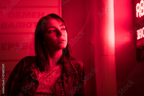 Cinematic night portrait of girl and neon lights