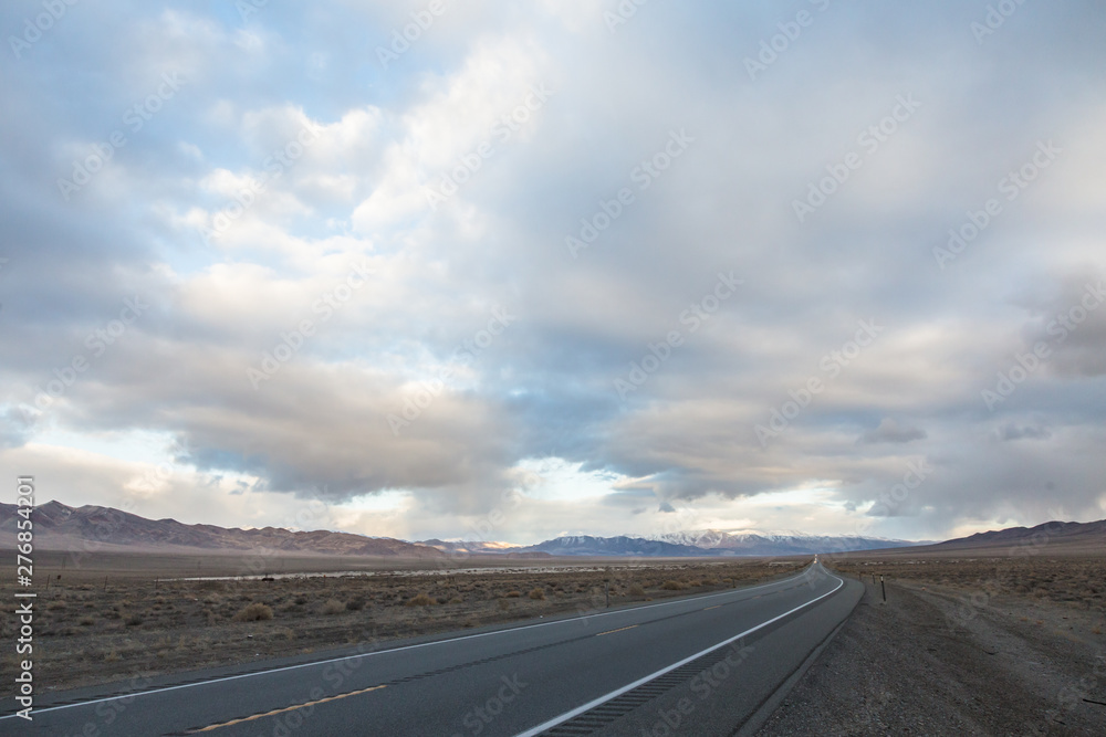 Road ahead with storm clouds above mountain Road ahead with storm clouds above mountain