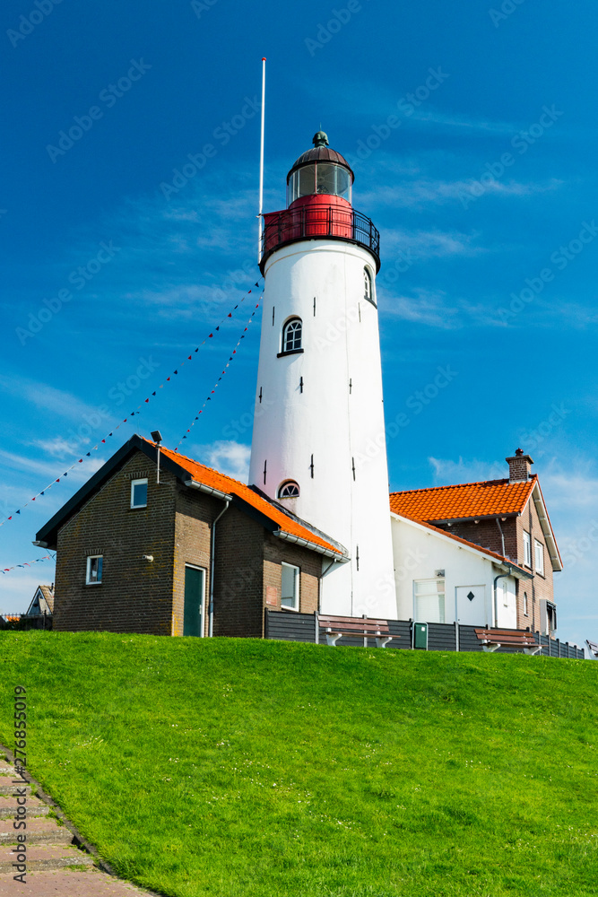 lighthouse on green hill along the IJsselmeer in Urk, The Netherlands