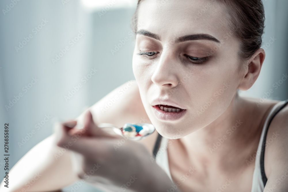 Portrait of sick girl that taking medicine Portrait of sick girl that taking medicine