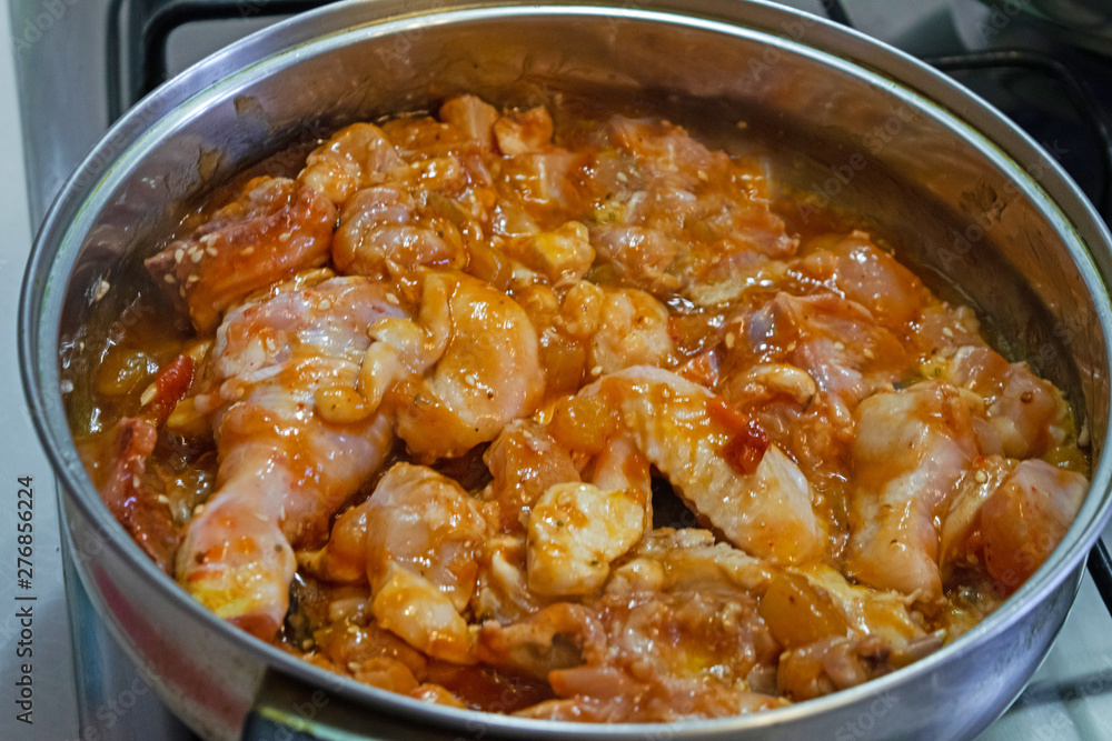 Slices of homemade chicken in a spicy honey sauce in a pan Slices of homemade chicken in a spicy honey sauce in a pan