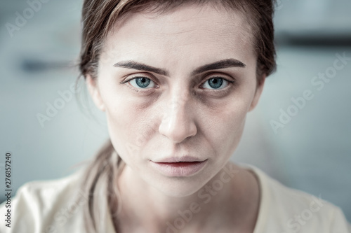 Sick brunette female person having eating disorder photo