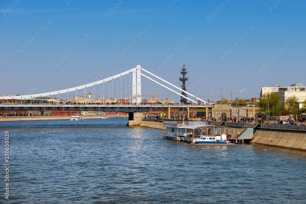 Moscow, Russia - May 6, 2019: View of the Crimean bridge over the Moscow River and tourist pleasure craft on a summer day