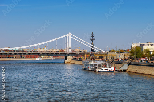 Moscow, Russia - May 6, 2019: View of the Crimean bridge over the Moscow River and tourist pleasure craft on a summer day © Konstantin
