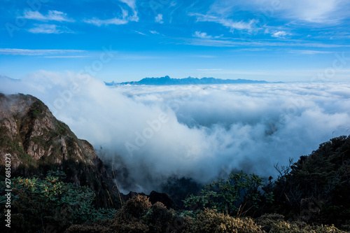 Beautiful sunrise and clouds with fog among mountain summits landscape