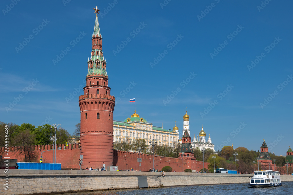 Moscow, Russia - May 6, 2019: View of the Moscow Kremlin and pleasure cruise ship on the Moscow River on a summer day