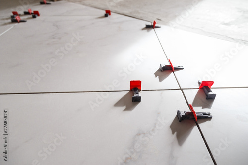 Tile leveling system with plastic clips and wedges