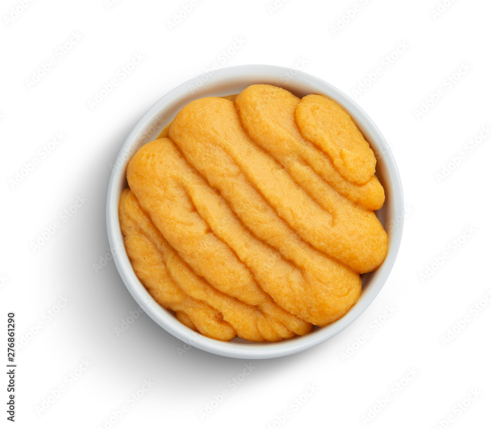 Pumpkin and carrot baby puree in bowl isolated on white background, top view Pumpkin and carrot baby puree in bowl isolated on white background, top view