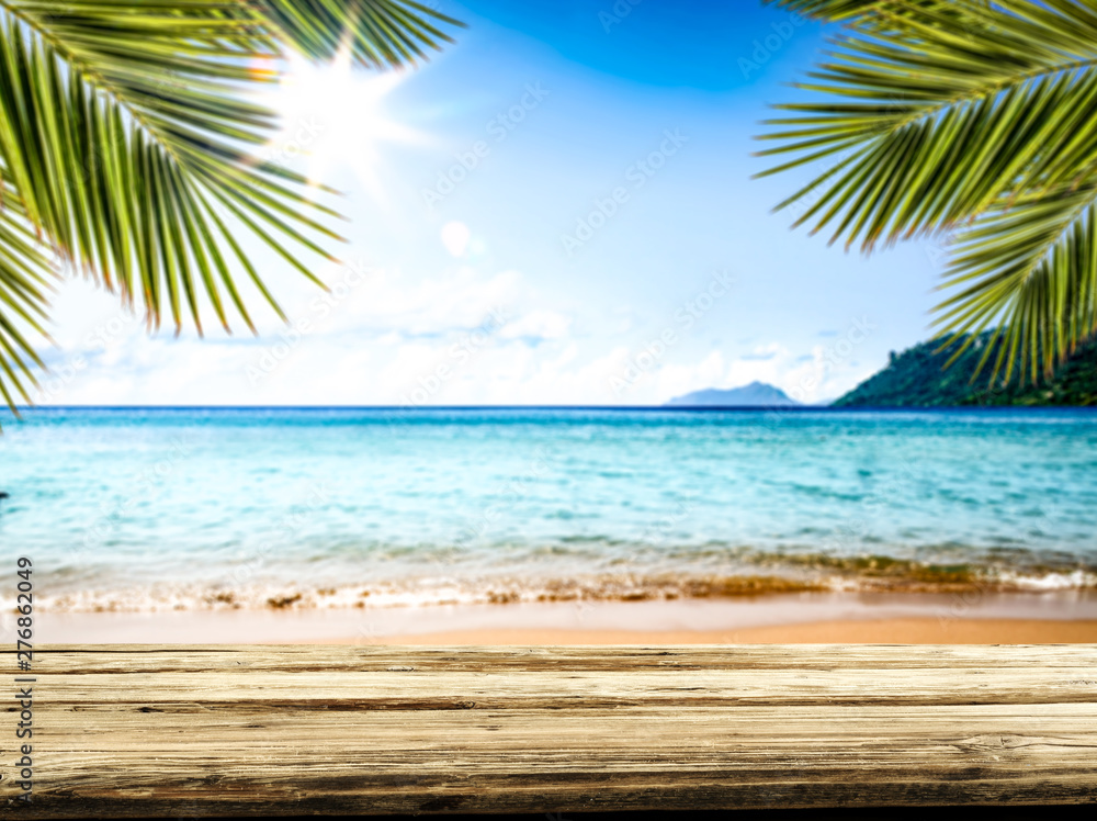 Desk of free space and summer beach background Desk of free space and summer beach background