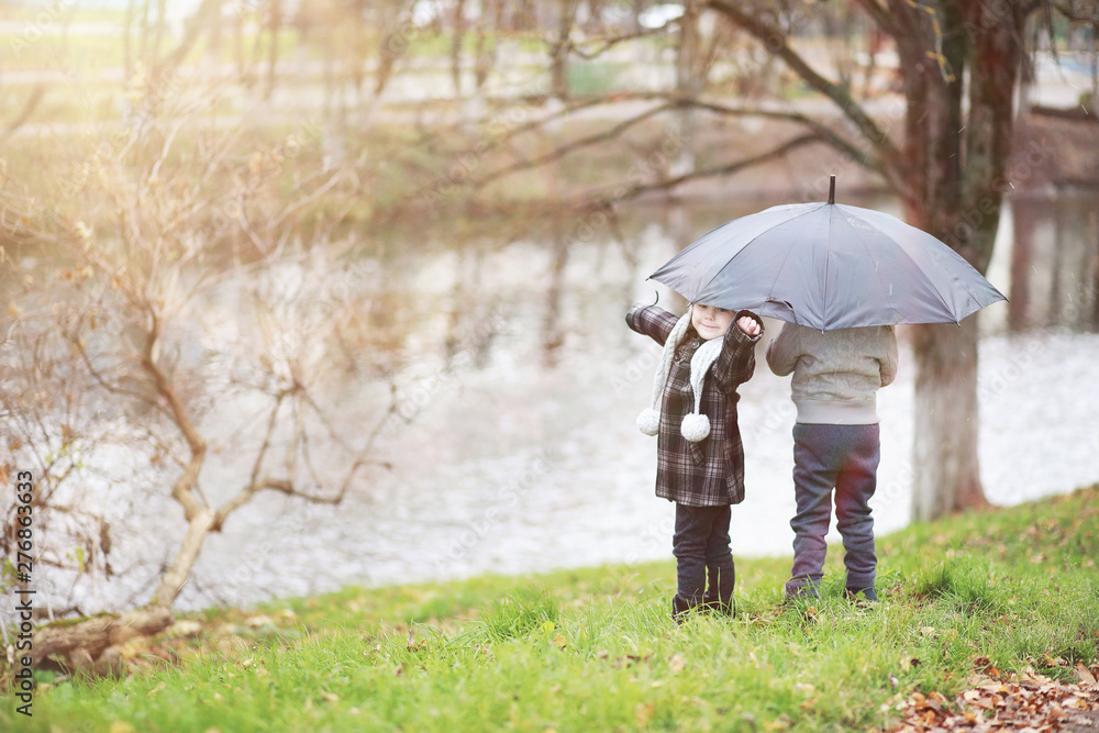 Children walk in the autumn park Children walk in the autumn park