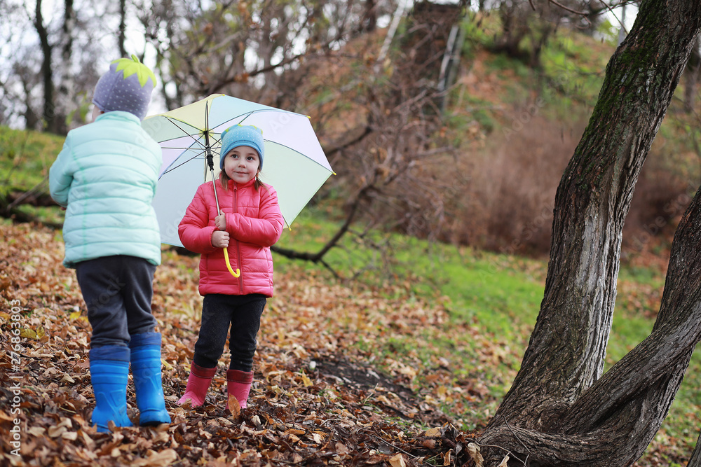 Children walk in the autumn park Children walk in the autumn park