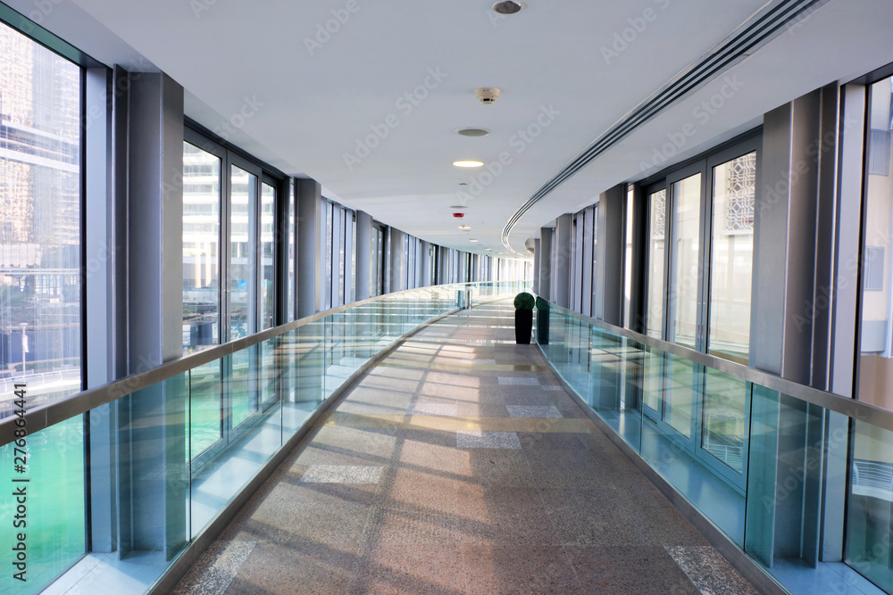Hallway between buildings with glass on sides Hallway between buildings with glass on sides