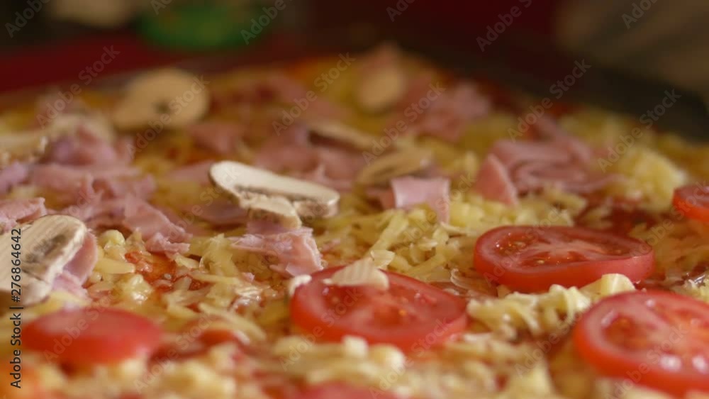 Close up shot adding mushrooms onto a pizza before baking it Close up shot adding mushrooms onto a pizza before baking it