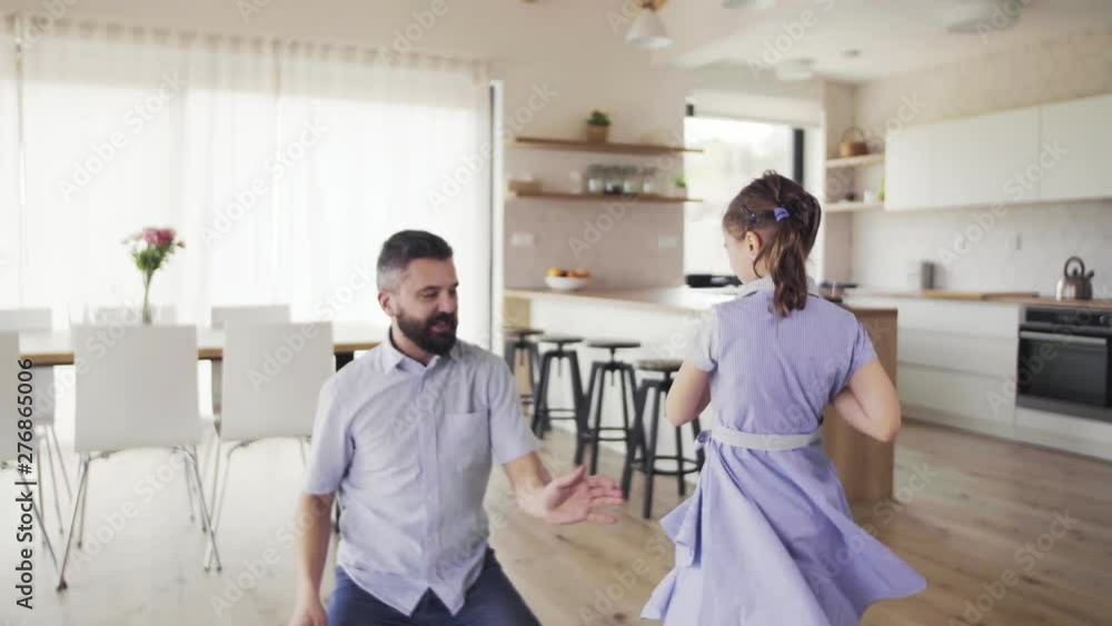 Mature father with small daughter playing indoors. Mature father with small daughter playing indoors.