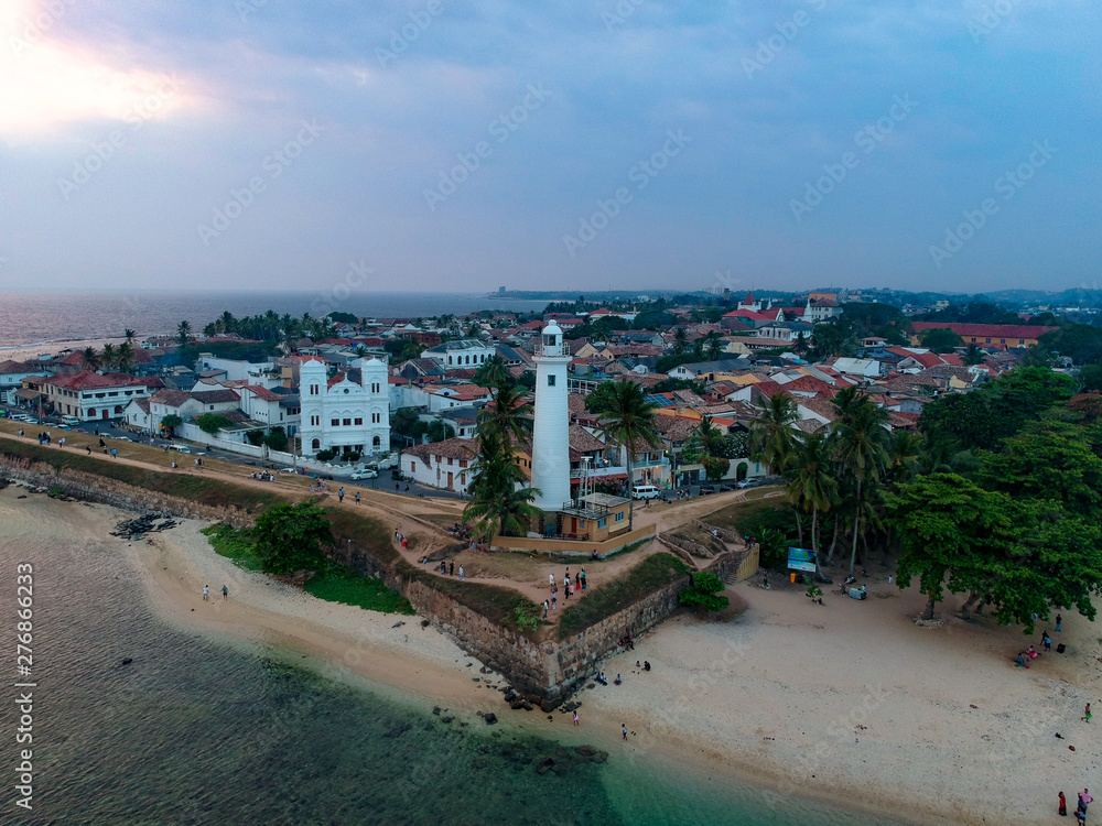 Aerial drone of Galle fort Lighthouse at sunset golden hour. Galle Dutch Fort, Sri lanka
