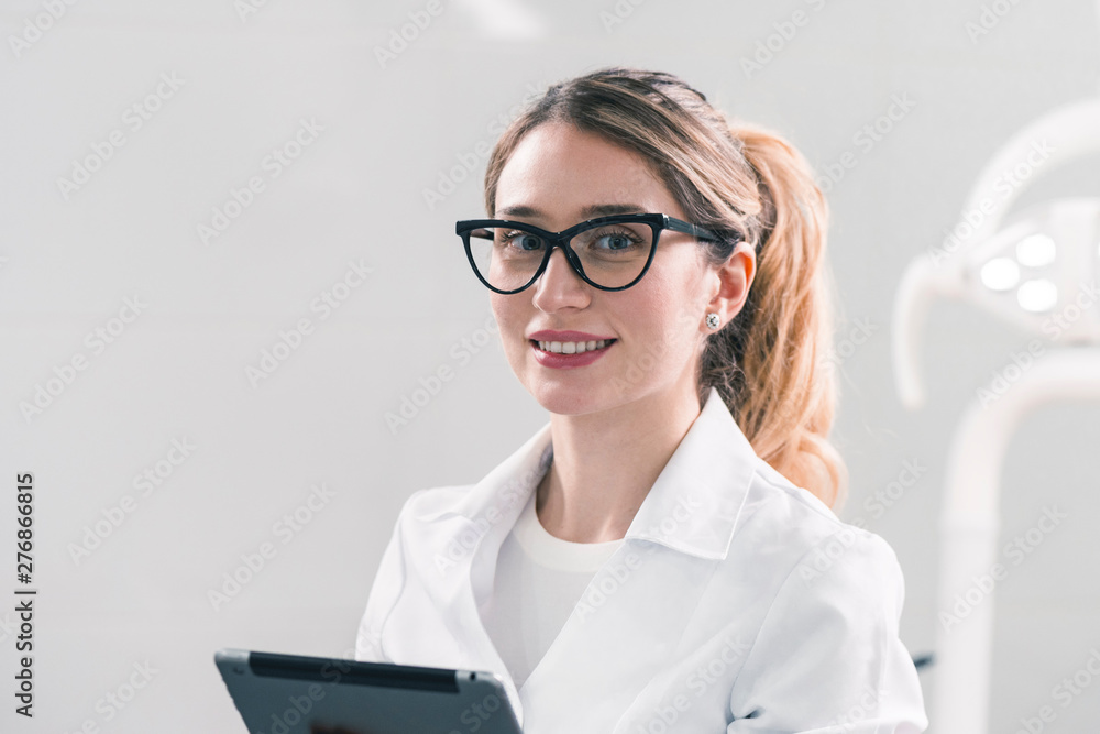 Young caucasian female dentist at the workplace in a dentistry cabinet Young caucasian female dentist at the workplace in a dentistry cabinet