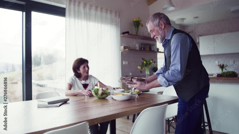Senior couple in love having lunch indoors at home, talking. Senior couple in love having lunch indoors at home, talking.