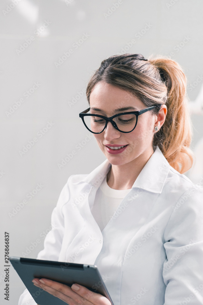 Young caucasian female dentist at the workplace in a dentistry cabinet Young caucasian female dentist at the workplace in a dentistry cabinet