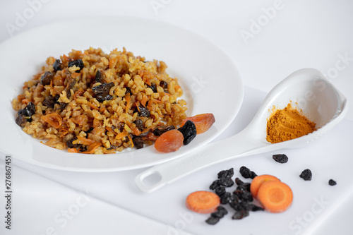 sweet pilaf with dried apricots, carrots, prunes, raisins and turmeric, cooked in olive oil in a slow cooker