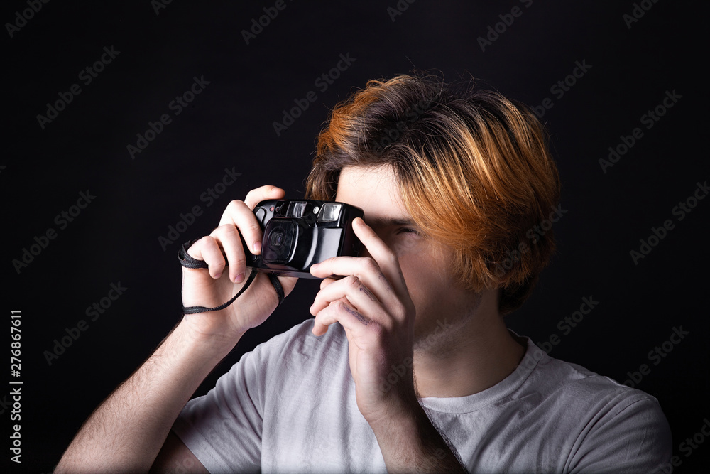 Young caucasian adult with old photo camera Young caucasian adult with old photo camera