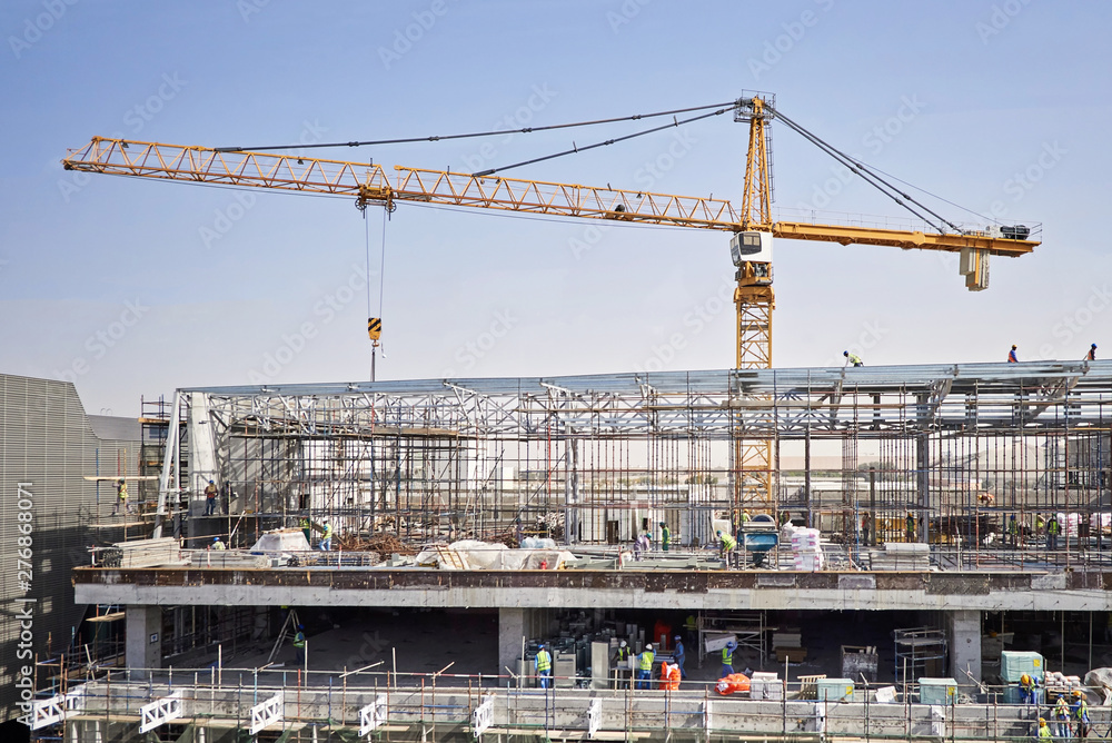 Construction site with cranes and people working