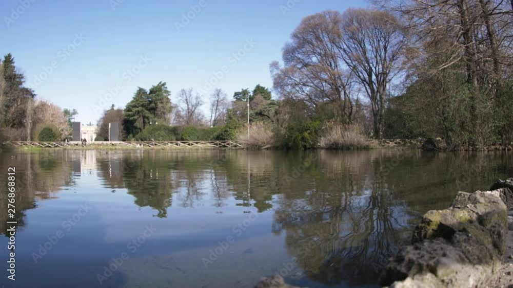 Sempione park lake in Milan, Italy. Ducks and pigeons in sunny day. Sempione park lake in Milan, Italy. Ducks and pigeons in sunny day.