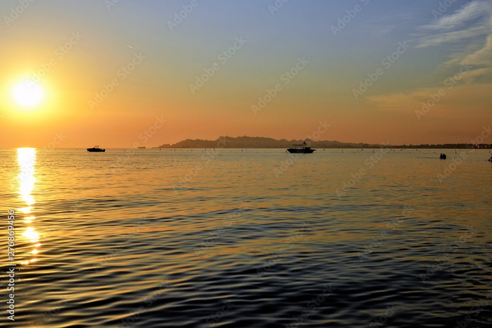 Sunset over Adriatic Sea. View from Golem / Durres, Albania. Beautiful sunset with Durres town silhouette in the distance Sunset over Adriatic Sea. View from Golem / Durres, Albania. Beautiful sunset with Durres town silhouette in the distance